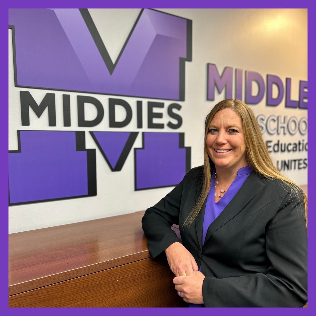 Picture of Jen Hayes next to Middletown Middies sign